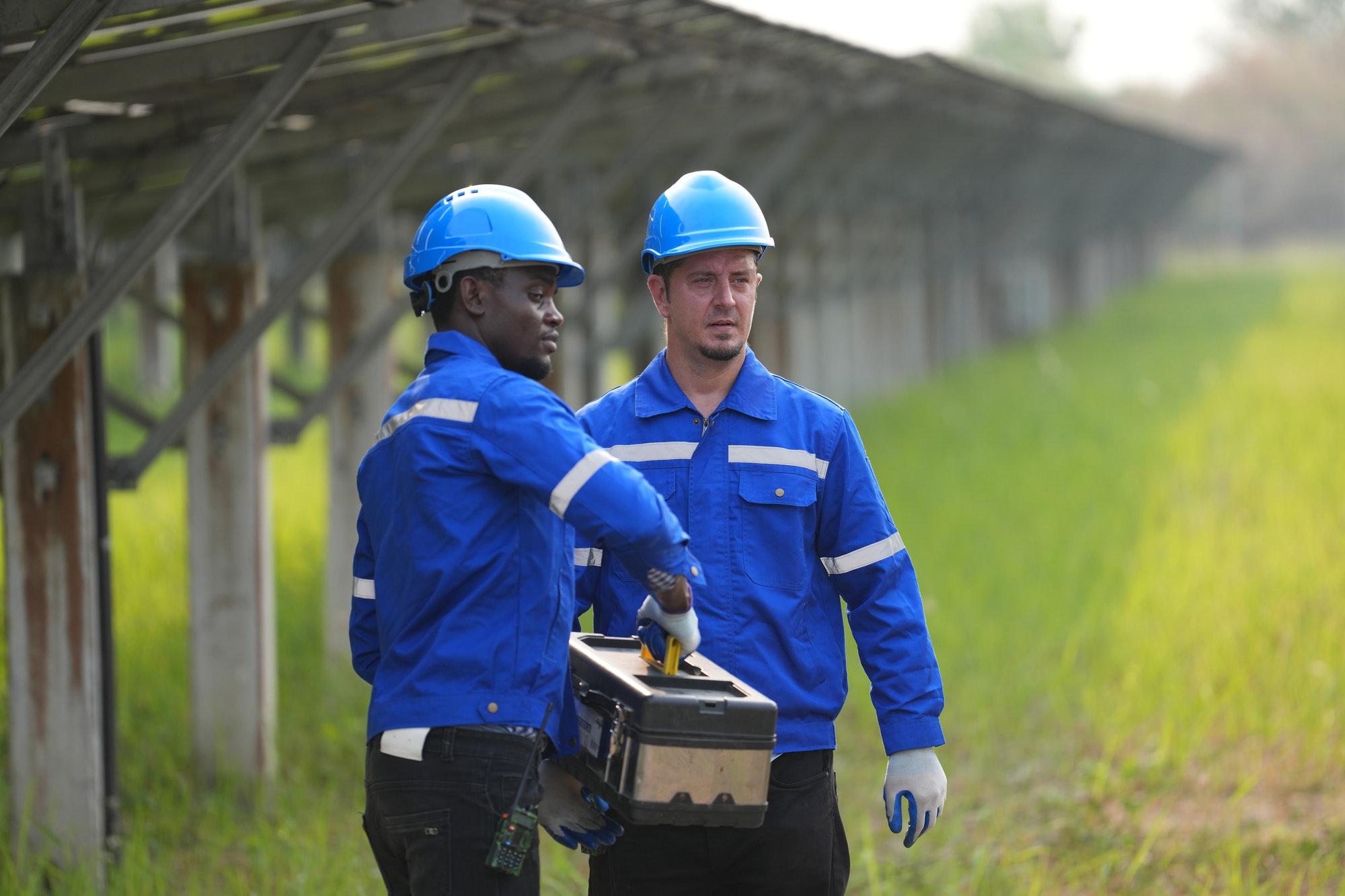 Solar power plant engineer examining photovoltaic panels. technician maintenance electric solution.